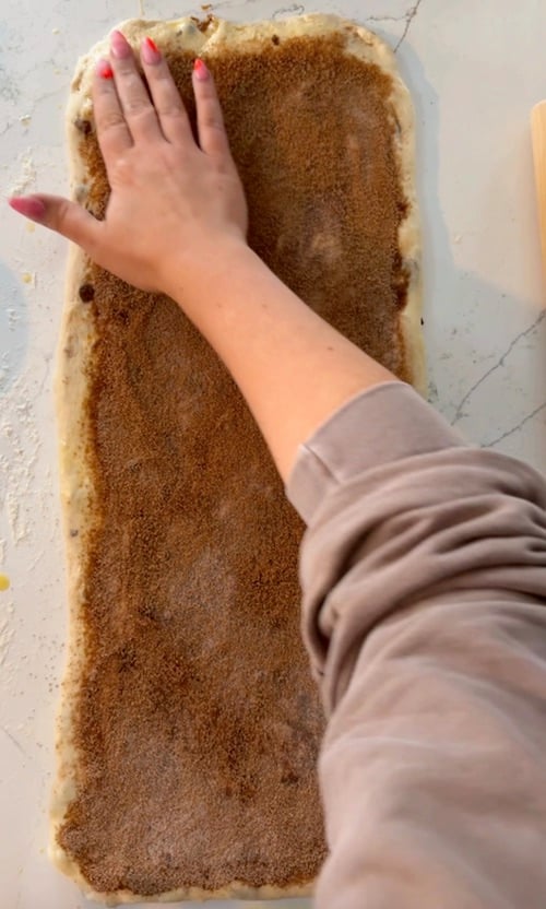 spreading cinnamon sugar