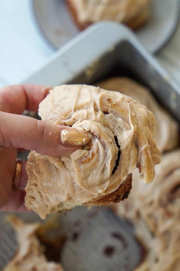 holding a sourdough cinnamon roll