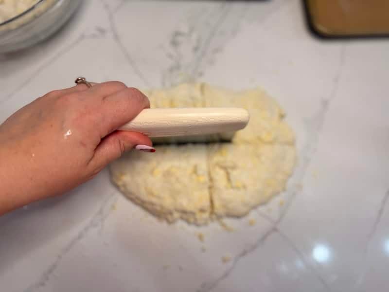 cutting dough into four pieces