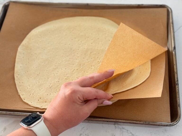 three thin crust pizzas on sheet tray