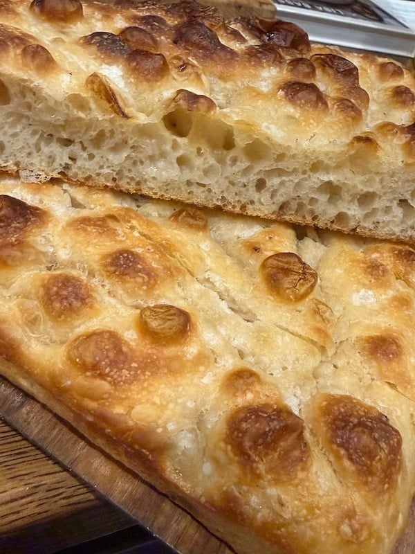 recipe tester loaf showing a golden top and open interior crumb