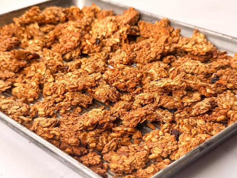 Oats & Honey Sourdough Granola clusters on a sheet pan