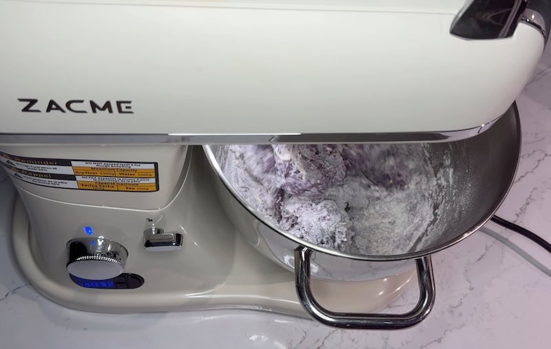 wild blueberry bagel dough mixing in a stand mixer