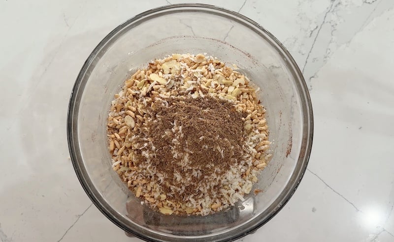 dry ingredients added to wet ingredients in a glass mixing bowl