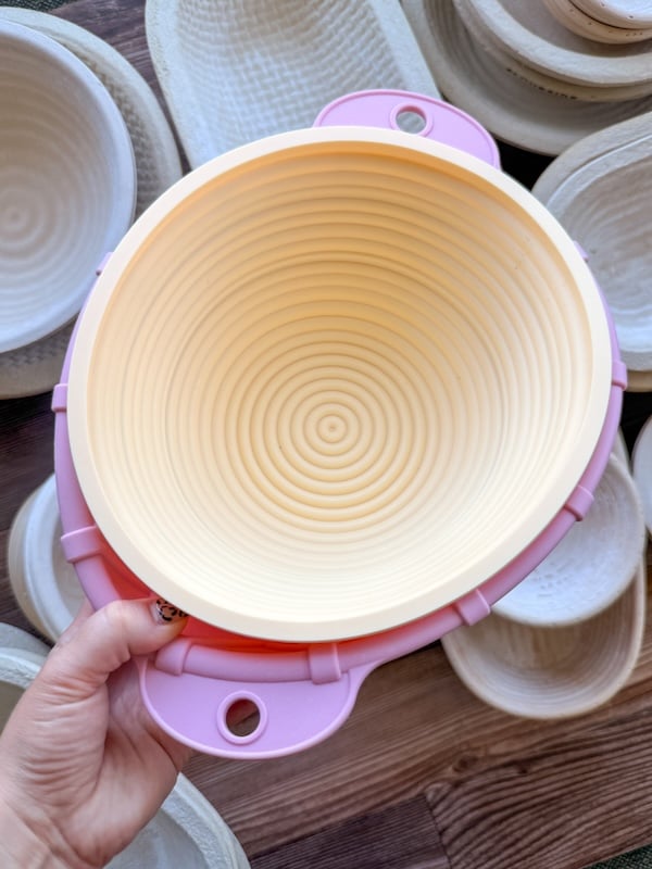 hand holding two silicone bannetons