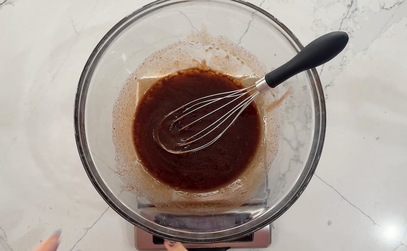 wet ingredients whisked in a glass bowl