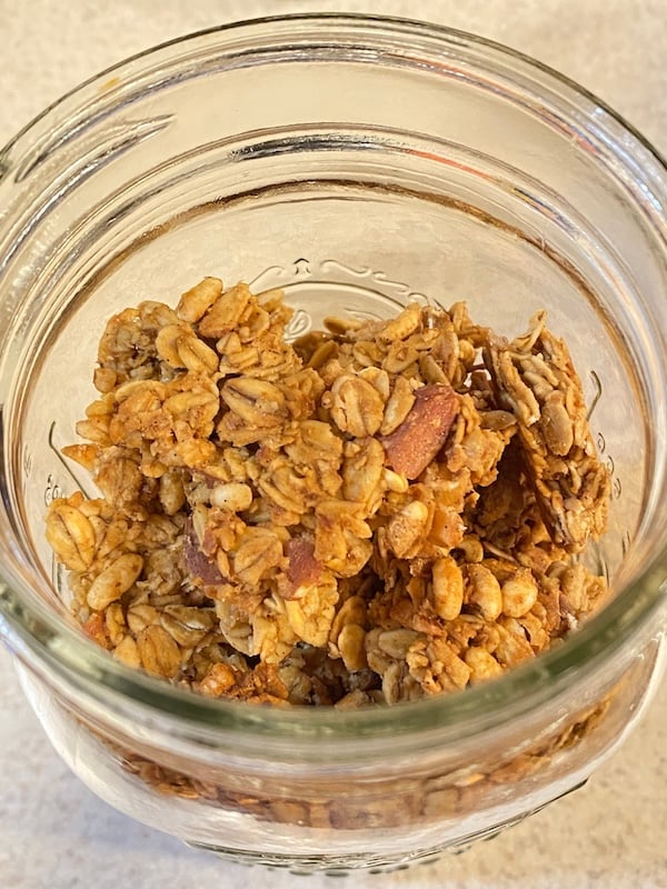 jar of granola made with old fashioned rolled oats and almonds