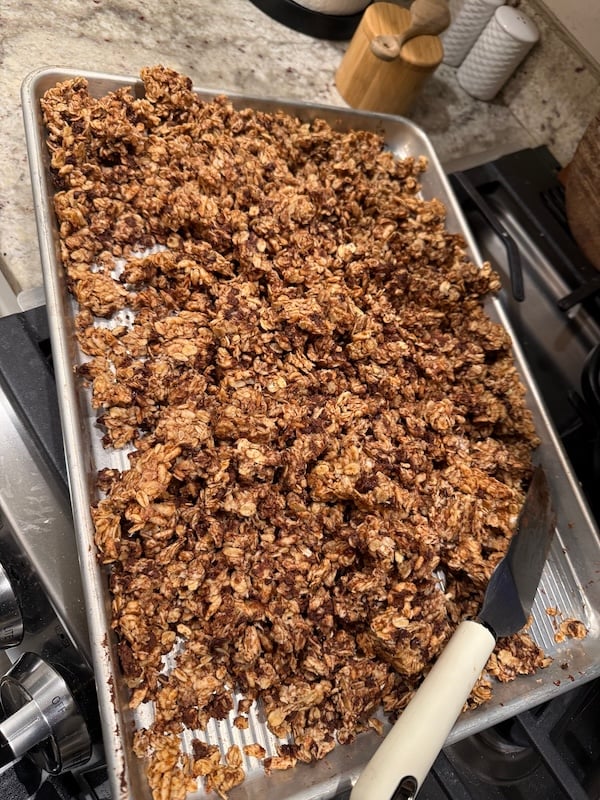 granola clusters broken up by a spatula