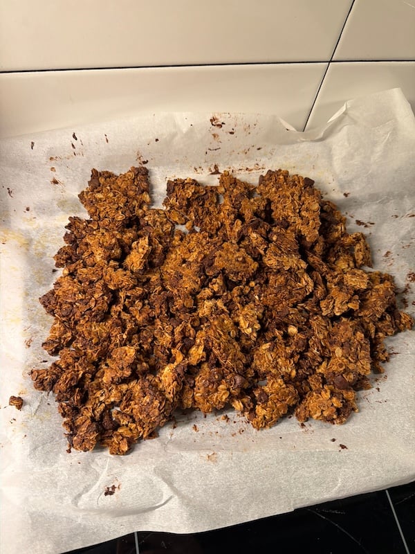 granola on a parchment lined sheet broken into large chunks