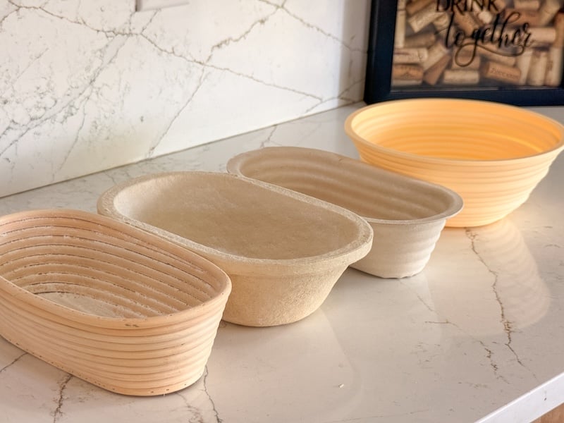 oval rattan, wood pulp, sugarcane, and silicone bannetons lined up on a counter