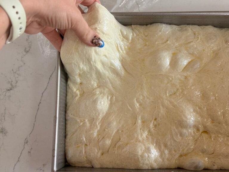 stretching out dough in pan