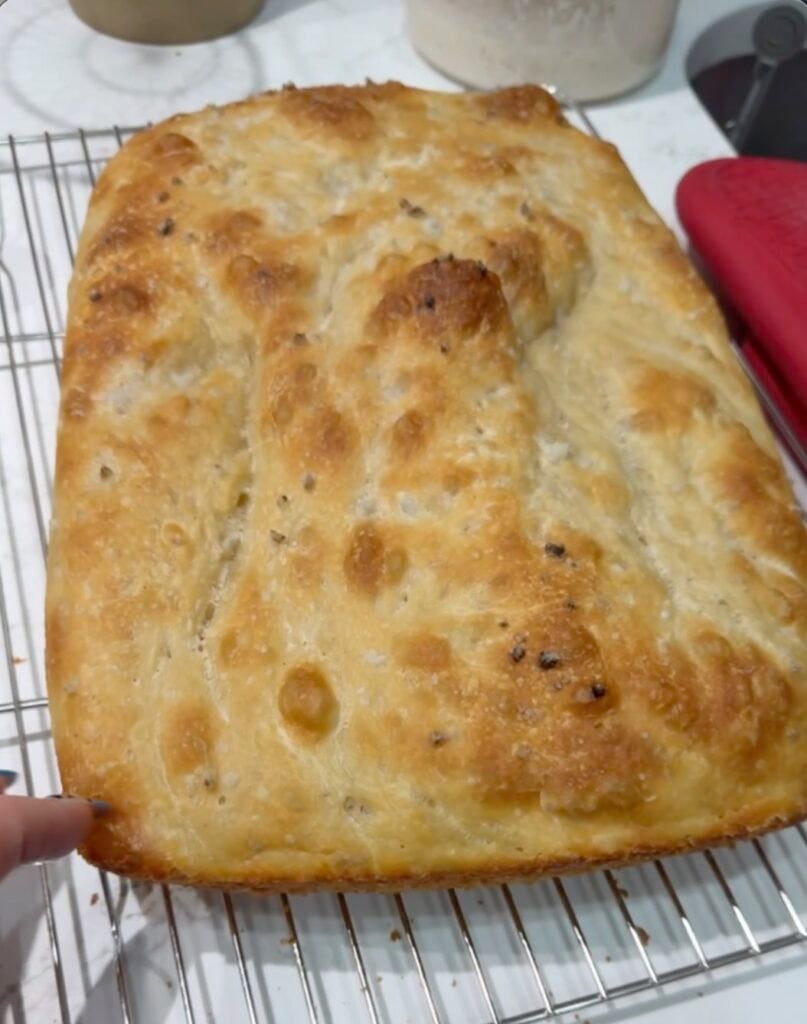test 9 same day focaccia in glass pan showing a lightly blistered golden top