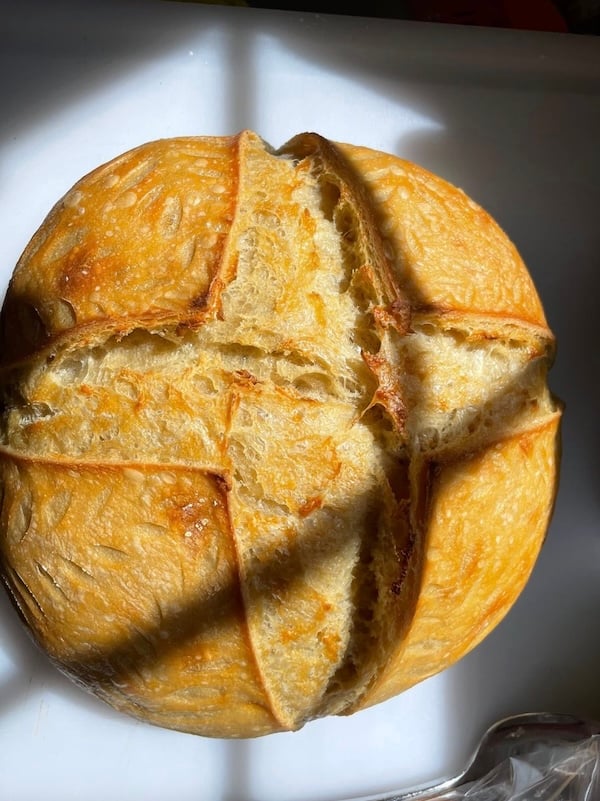 50% einkorn sourdough boule with an X score pattern, viewed from above