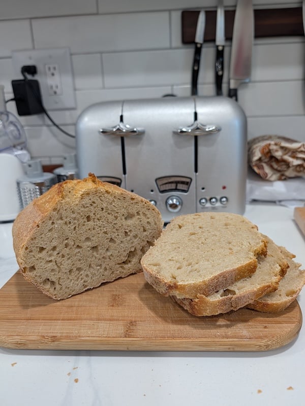 50% einkorn sourdough sandwich loaf sliced on a cutting board, showing the crumb