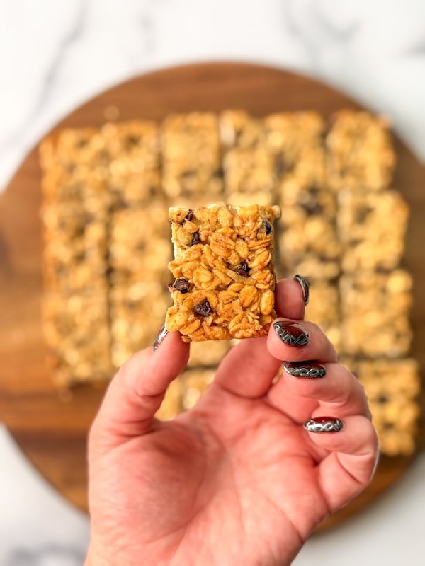Holding a granola bar upside down to show the golden bottom