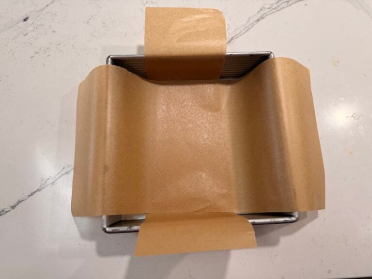 prepping square pan with parchment paper handles