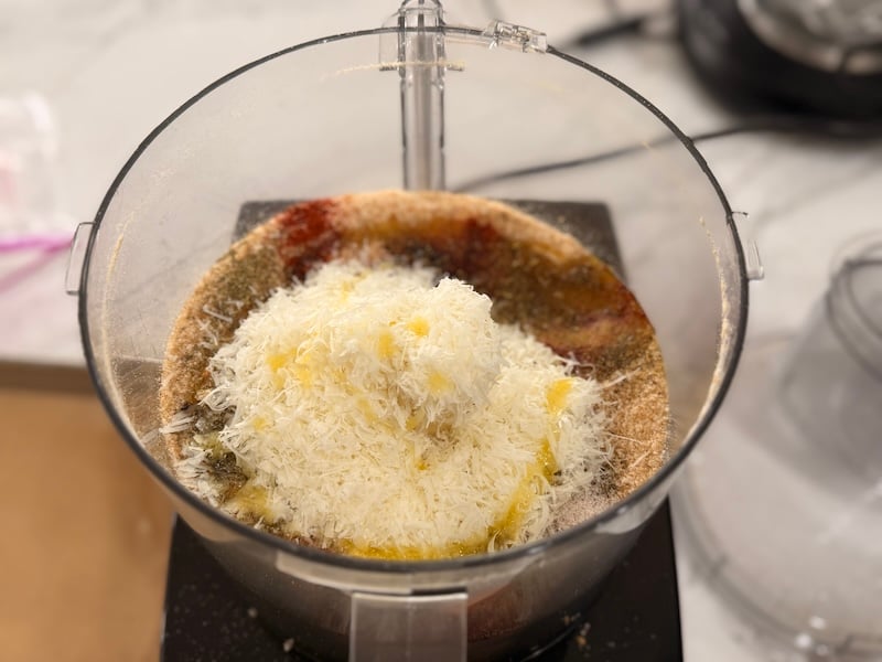 freshly grated parmesan cheese and seasonings added to sourdough breadcrumbs in a food processor bowl