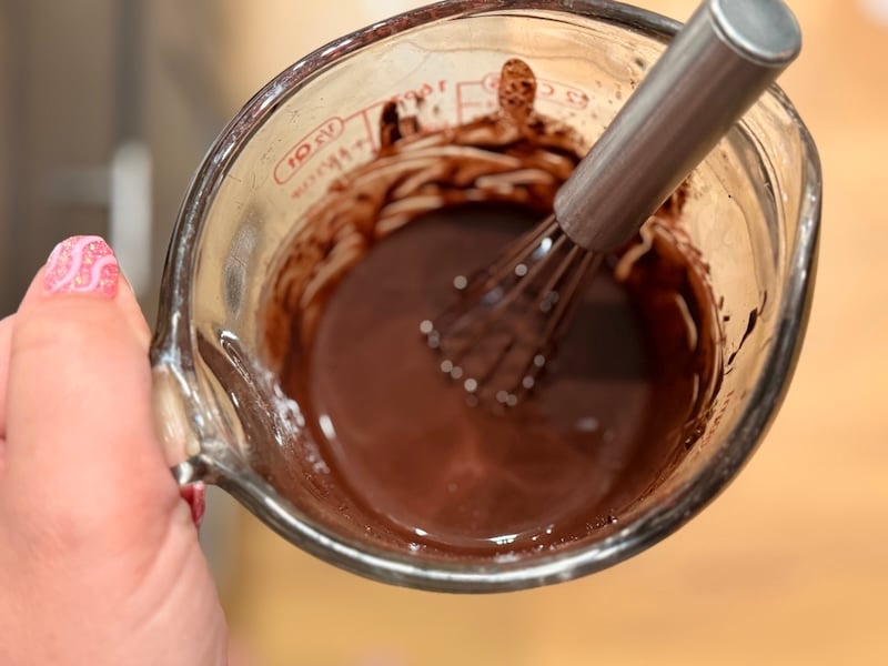 Bloomed cocoa and espresso mixture whisked in a measuring cup