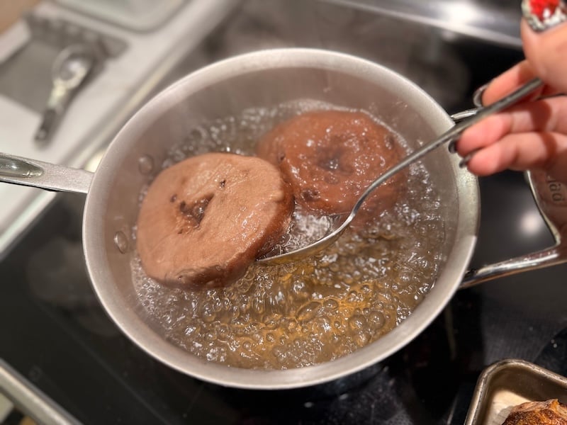 flipping a boiling chocolate bagel with a regular slotted spoon