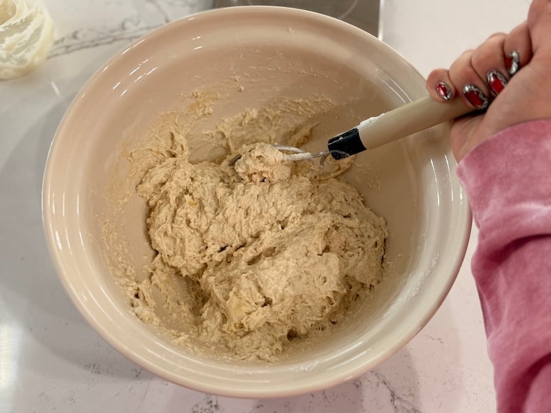 high-hydration sourdough focaccia dough being mixed with a Danish dough whisk