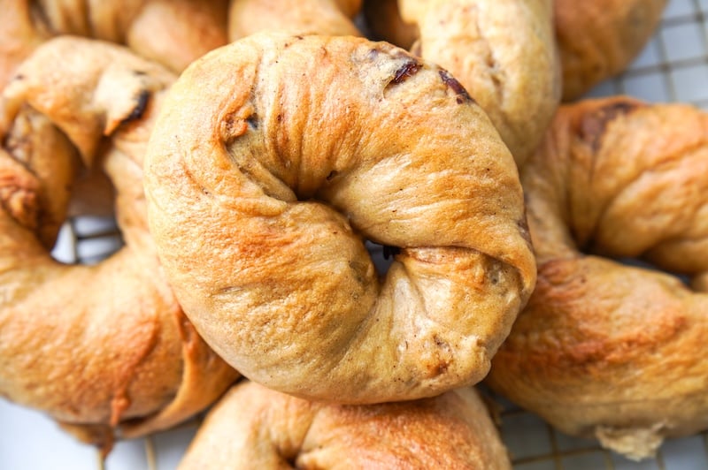 a pile of sourdough cinnamon raisin bagels