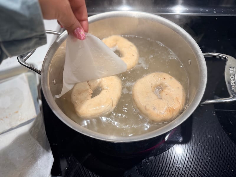 3 bagels in a pot of boiling water
