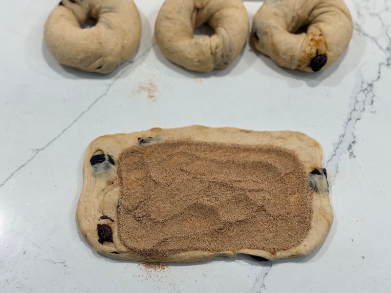 cinnamon sugar mixture on flattened dough