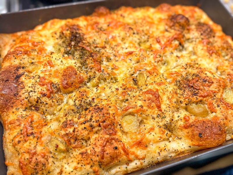 garlic and cheese sourdough focaccia in the pan after baking