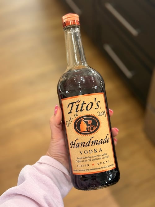 homemade vanilla extract in a titos vodka bottle