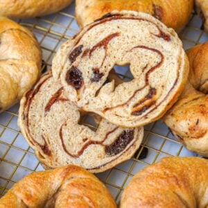 marbled cinnamon swirl raisin sourdough bagels on a cooling rack