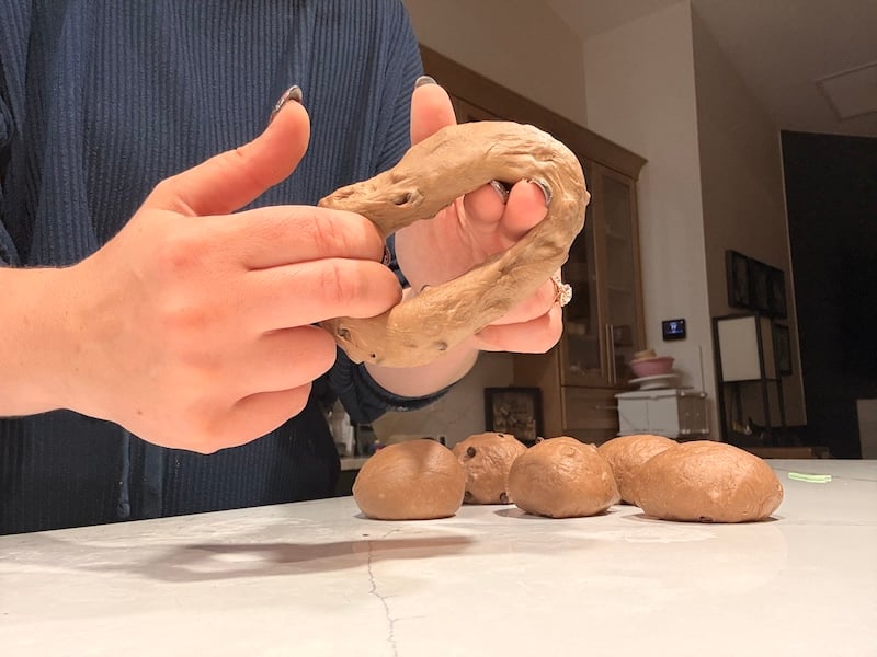 stretching the center hole of double chocolate bagel dough during shaping