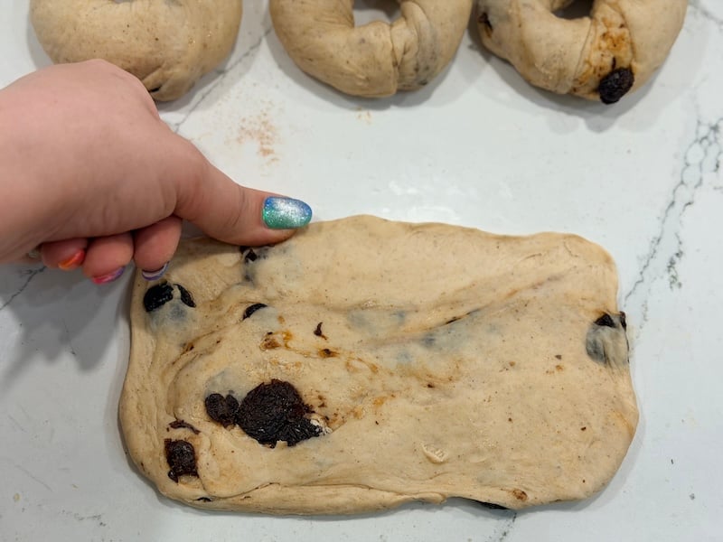 flattened bagel dough showing thin top edge