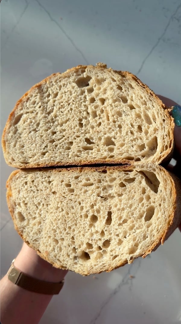 cut loaf of hint of rye sourdough bread showing a soft, airy crumb