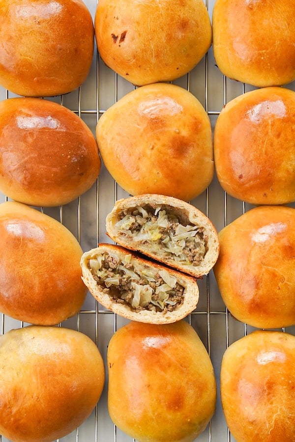 twelve sourdough runzas bierocks on a cooling rack