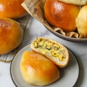 display of sourdough bierocks in a bowl on a plate and on a cooling rack