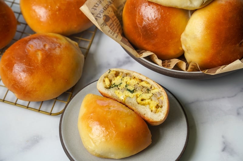 display of sourdough bierocks in a bowl on a plate and on a cooling rack
