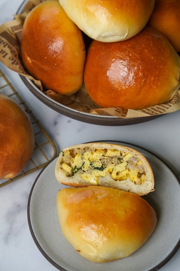 sourdough breakfast pockets with sausage, egg, and cheese filling, surrounded by golden-brown baked pockets