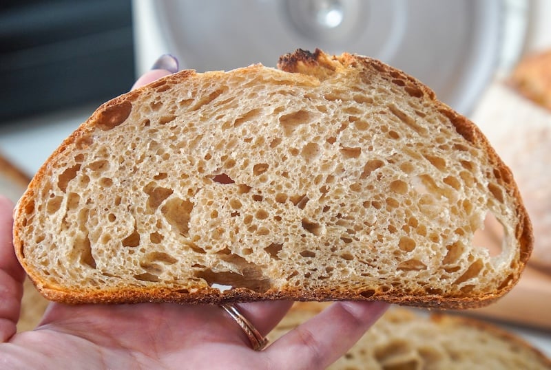 holding a slice of hint of rye sourdough bread