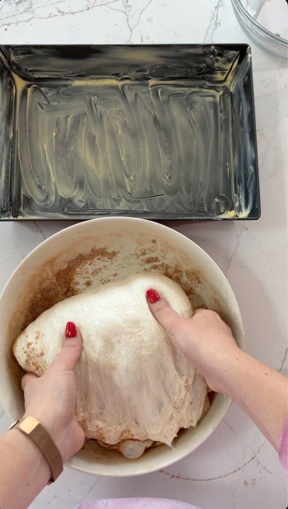 moving the marbled focaccia dough to the pan for final proof