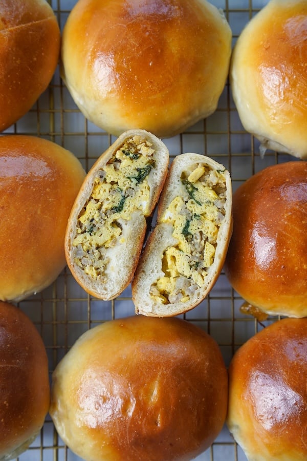 sliced in half sourdough breakfast bierock showing scrambled egg and sausage filling