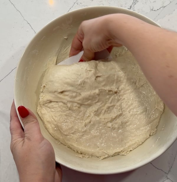 sliding bowl scraper under the dough