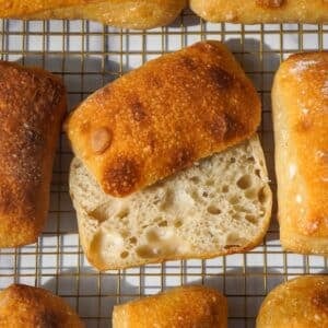 ciabatta rolls on a cooling rack looking gorgeous