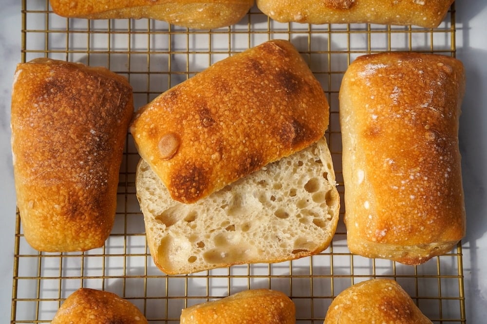 sliced in half ciabatta roll showing the open airy crumb
