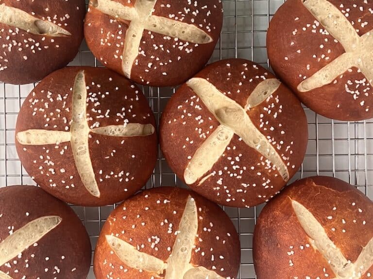 sourdough pretzel buns on a cooling rack
