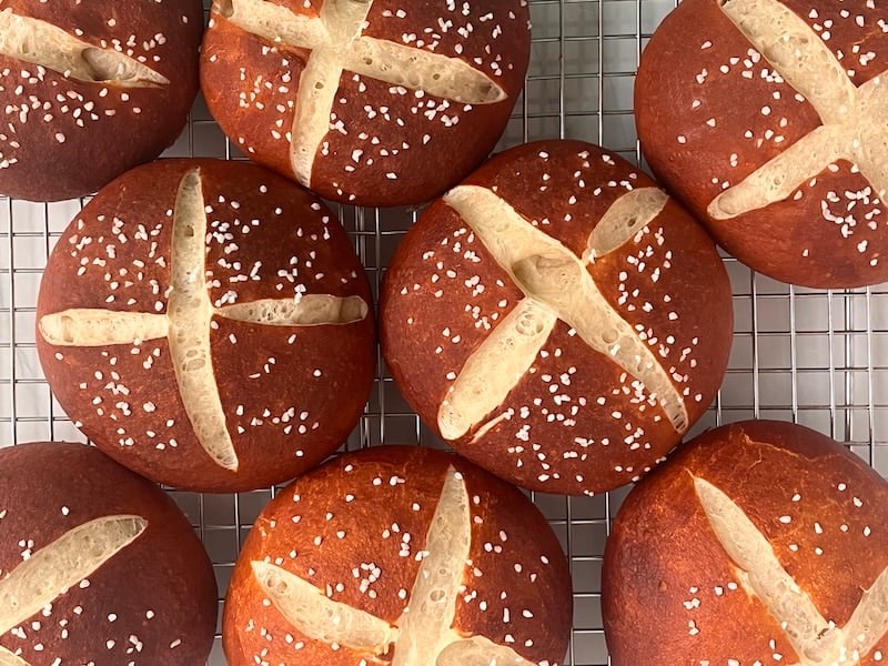sourdough pretzel buns on a cooling rack
