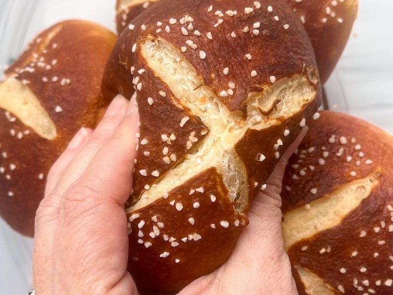 squeezing the soft sourdough pretzel bun