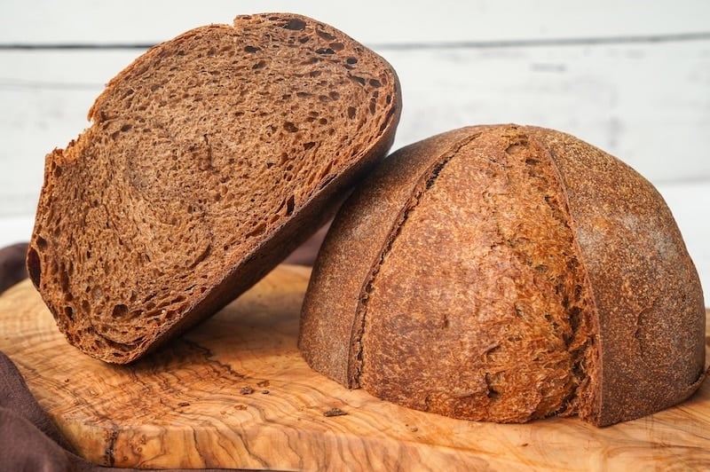 brown bread cut in half to show the tight crumb