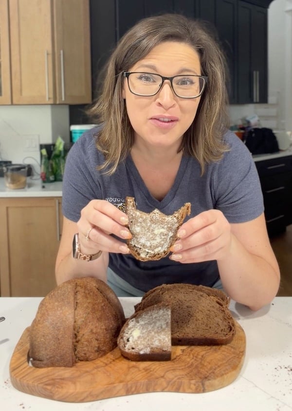 Rebekah smiling while eating delicioius brown bread