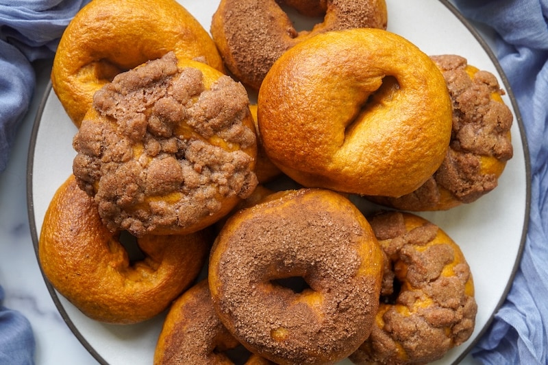 serving platter with lots of pumpkin sourdough bagels