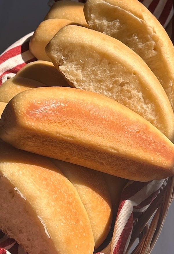 sun shining down on basket full of hawaiian hot dog buns